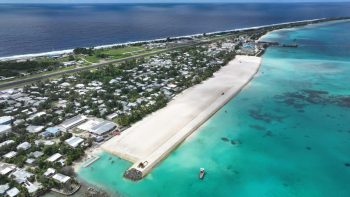Aerial view of Tuvalu's coast with warning system infrastructure.